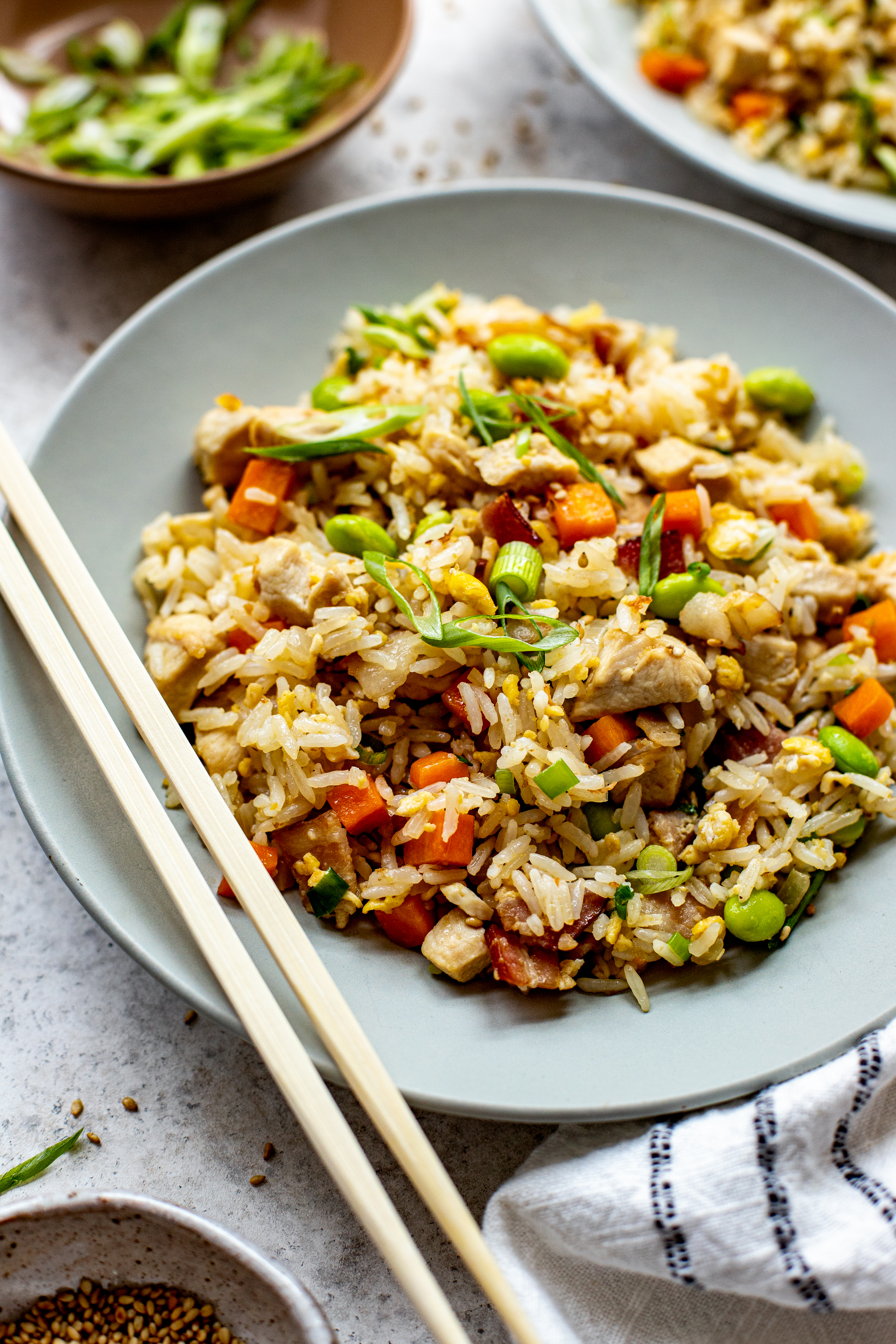 fried rice in a bowl with chopsticks on the side. 