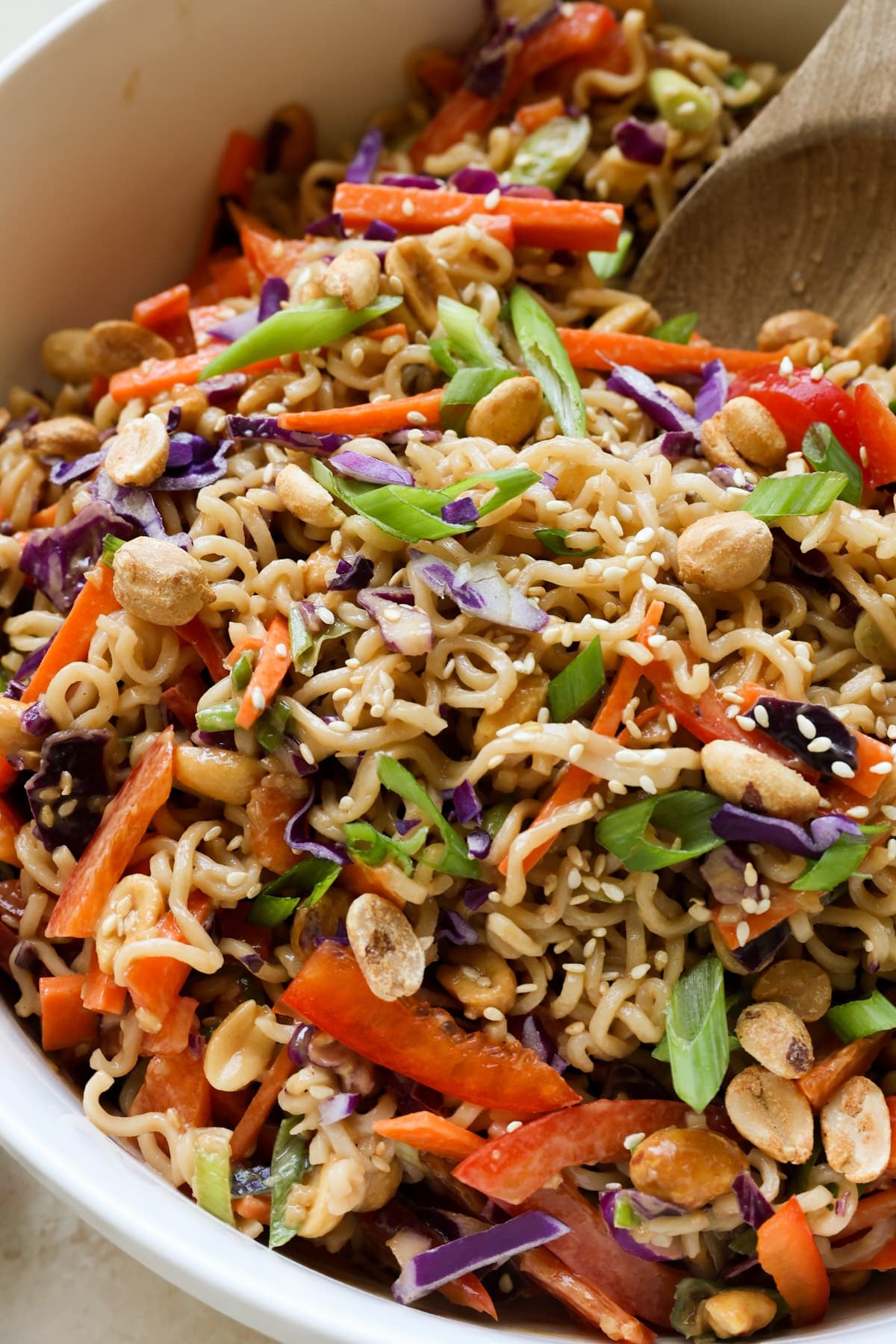 cold noodle salad in a bowl garnished with green onions.
