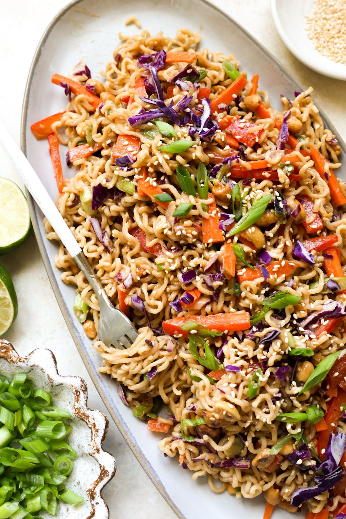 cold noodle salad on a plate garnished with green onions.