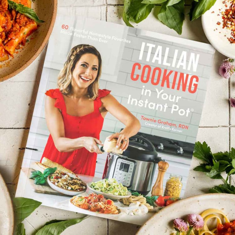 Cookbook surrounded by fresh ingredients.