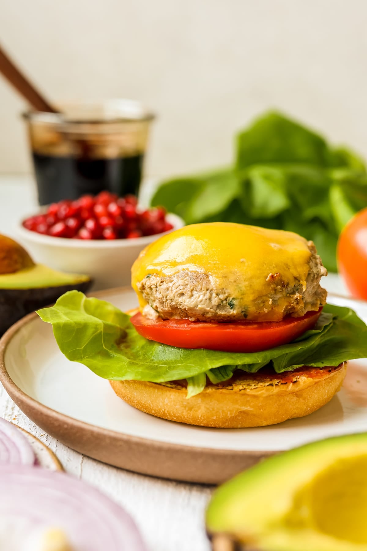 a turkey burger on a brioche bun with lettuce and tomato.