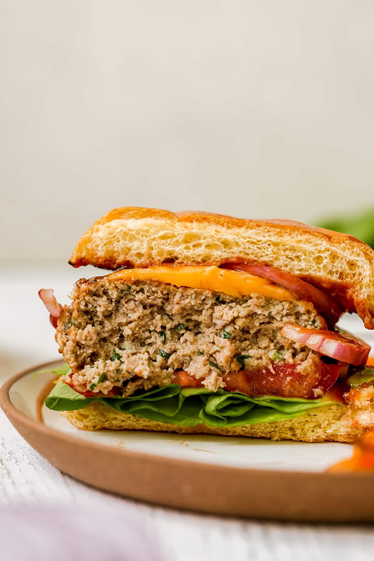a burger cut in half on a bun. 