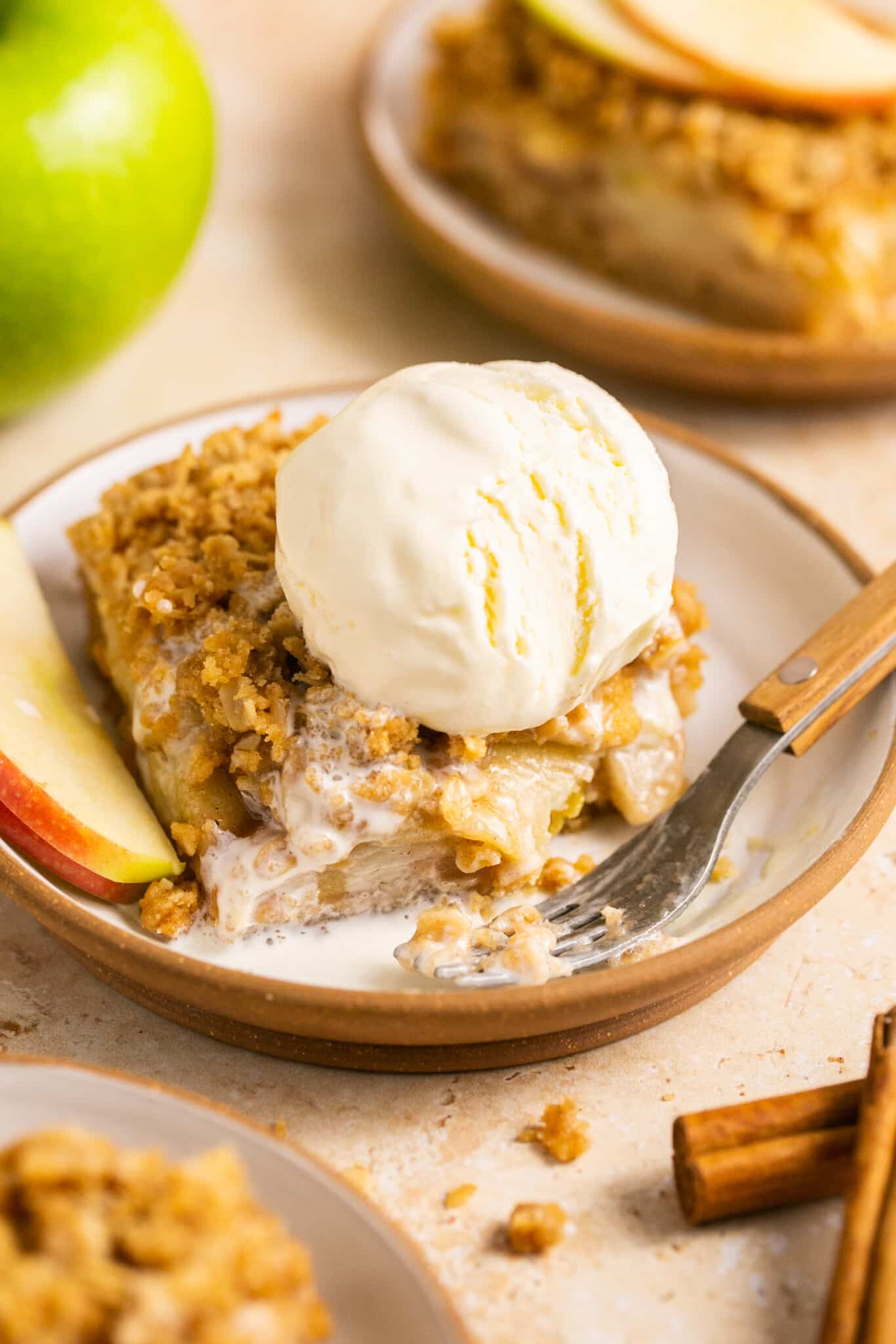 Apple pie bar on a plate with ice cream on top. 