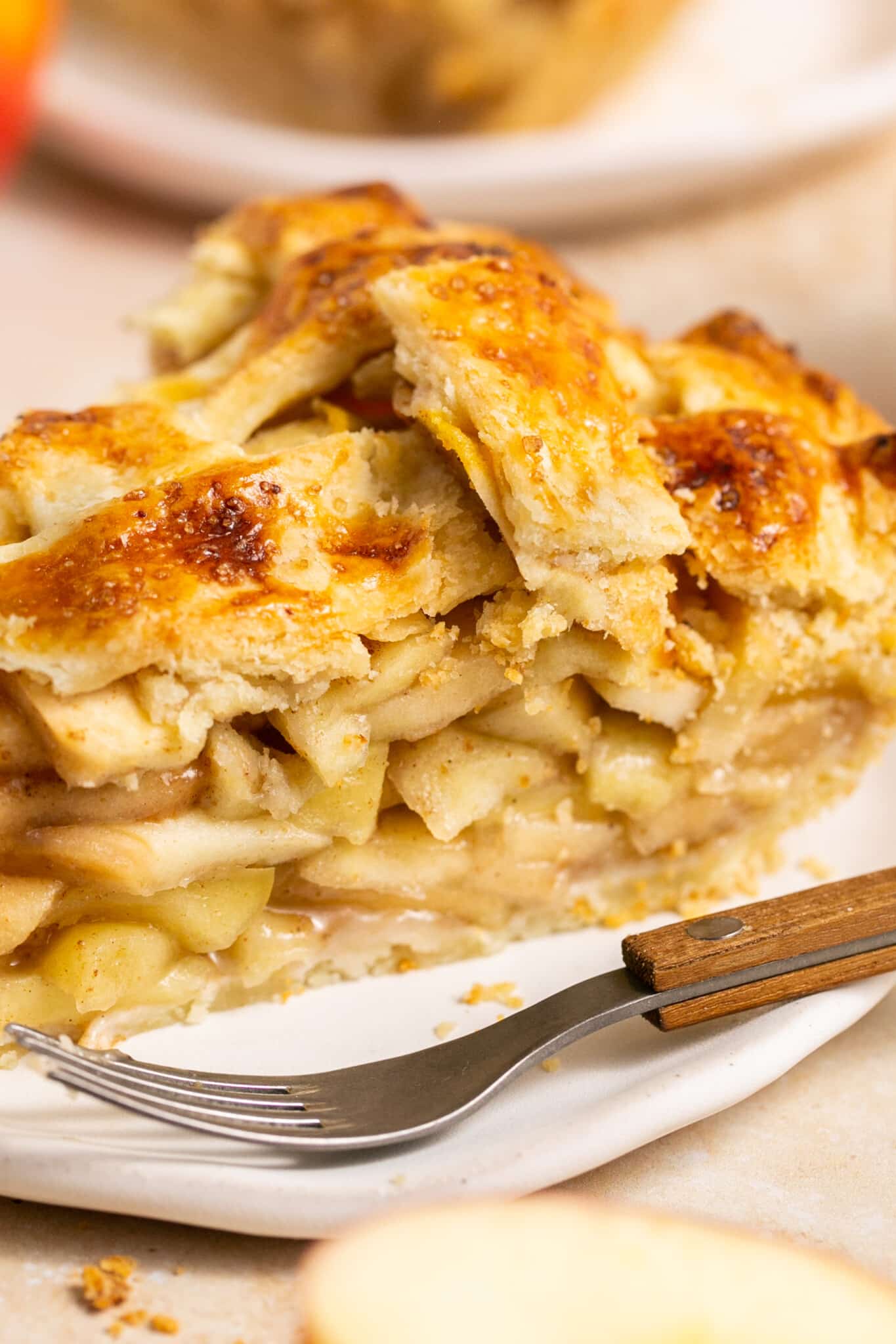 a slice of apple pie on a white plate. 