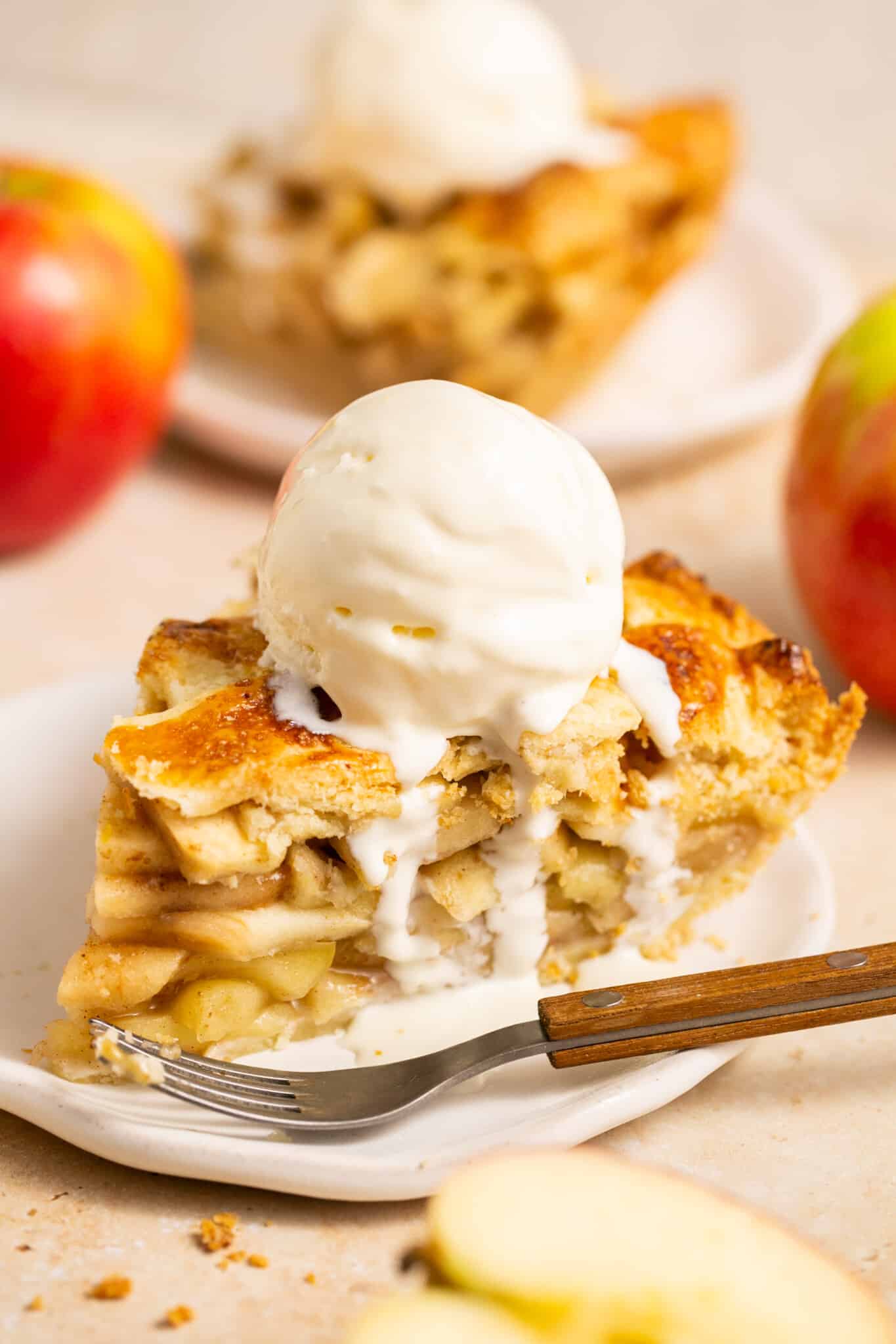 a piece of pie on a plate with vanilla bean ice cream on top. 