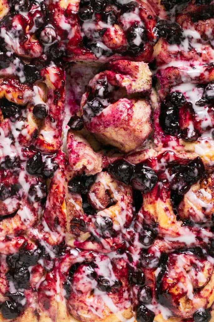 An up close image of cinnamon rolls made with blueberries. 