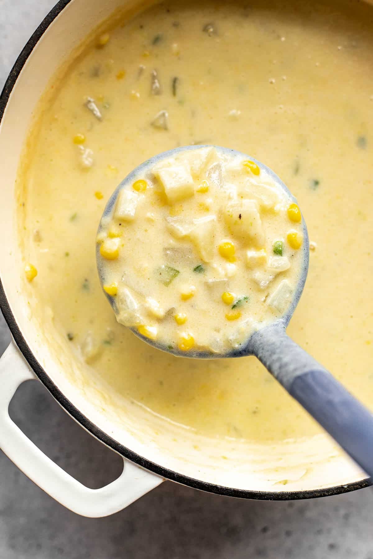 corn chowder in a ladle. 