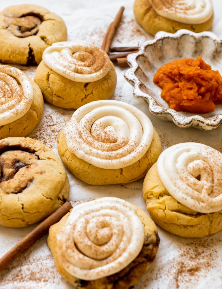 pumpkin cookies topped with cream cheese frosting and pumpkin pie spice.