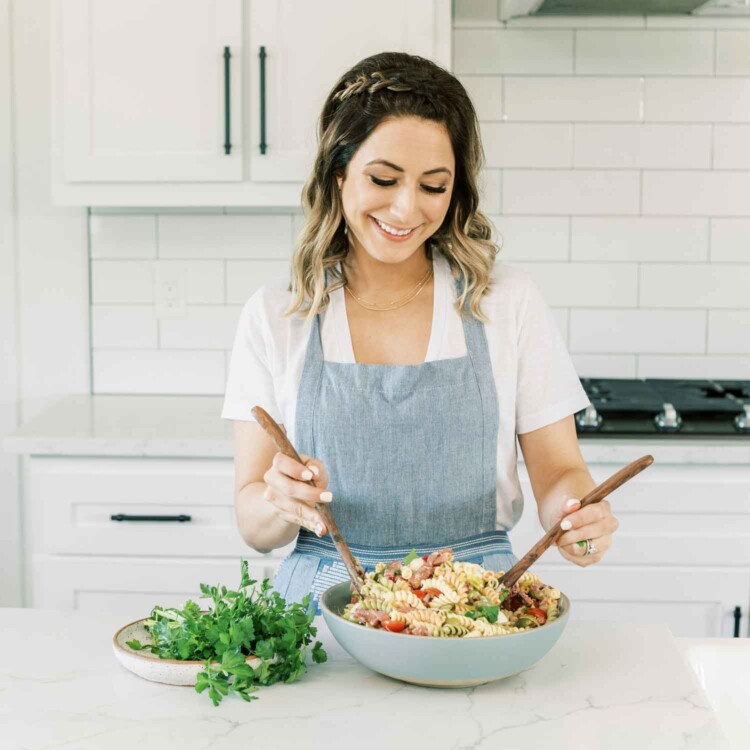 Portrait of Tawnie mixing pasta.