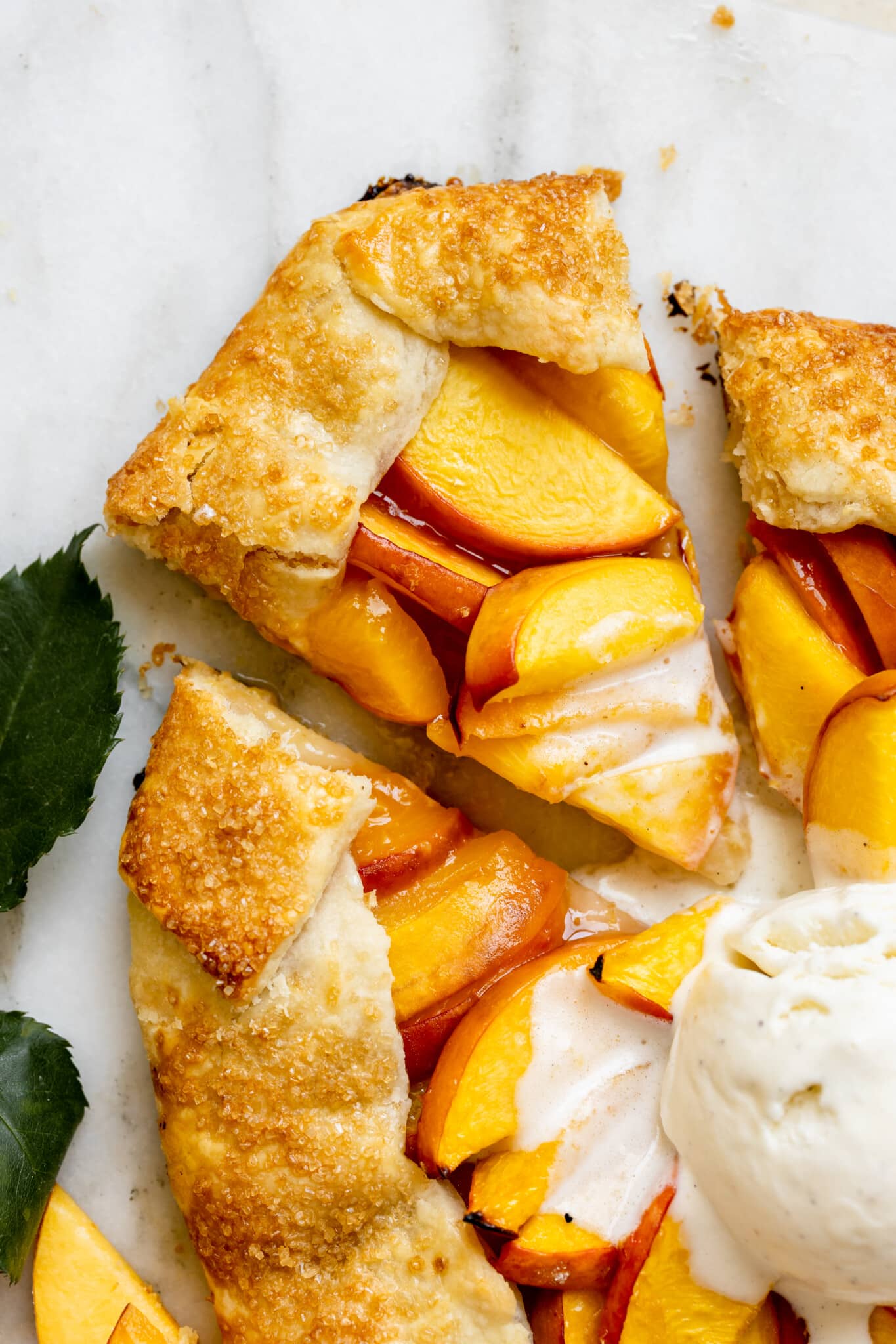 a freshly baked peach galette topped with vanilla ice cream. 