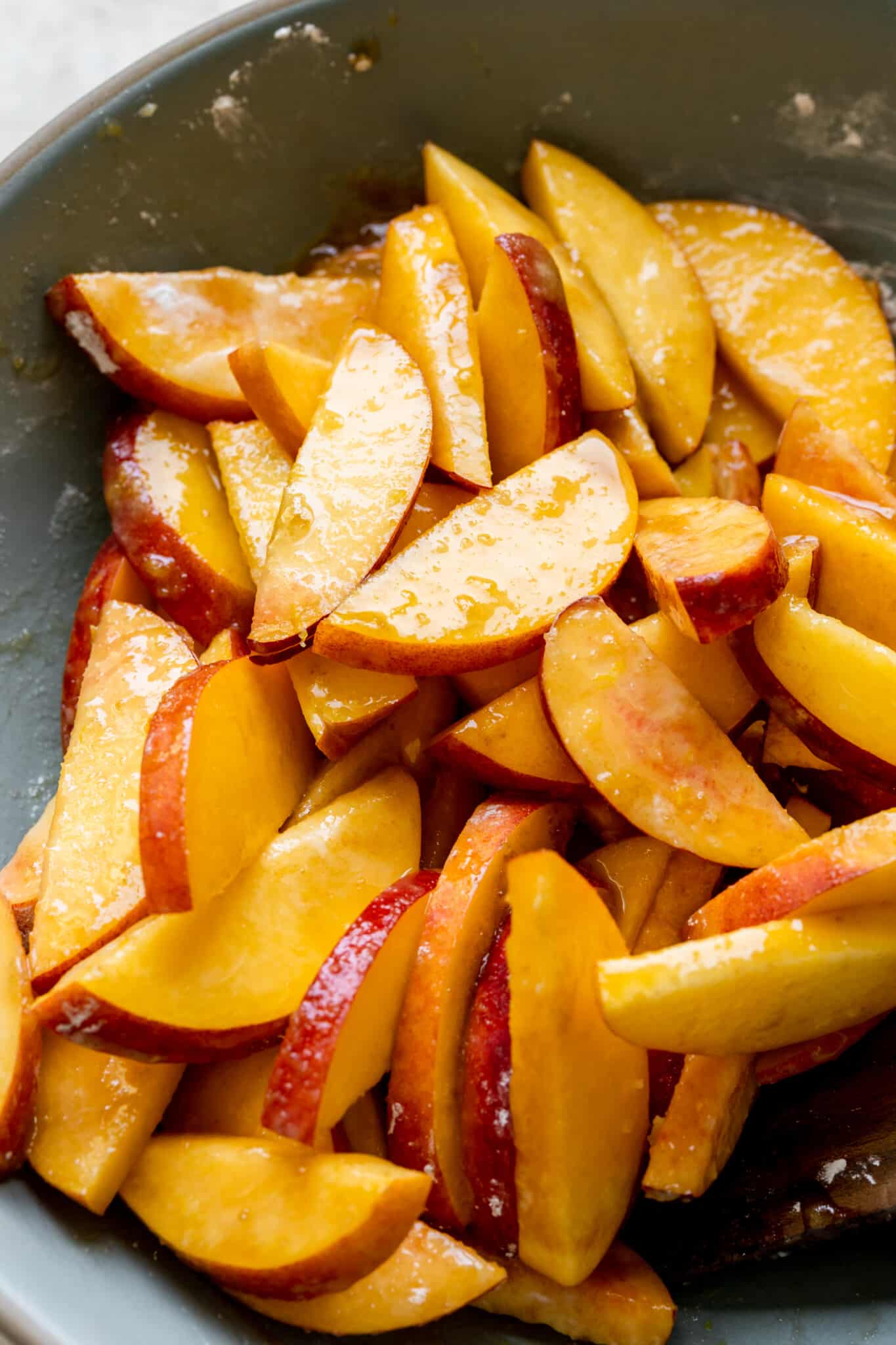 fresh peaches in a blue bowl. 