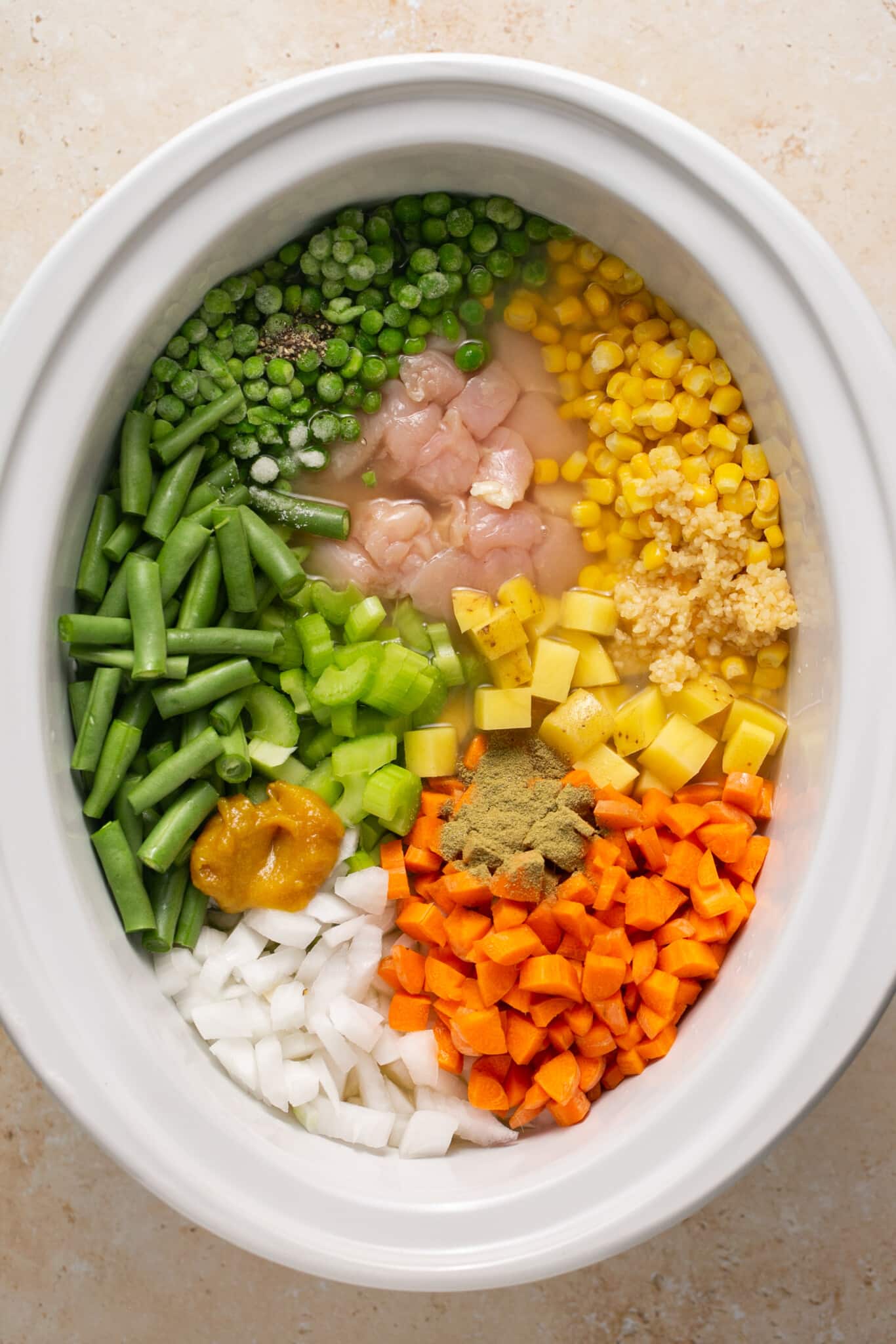 veggies and chicken in a crock pot.