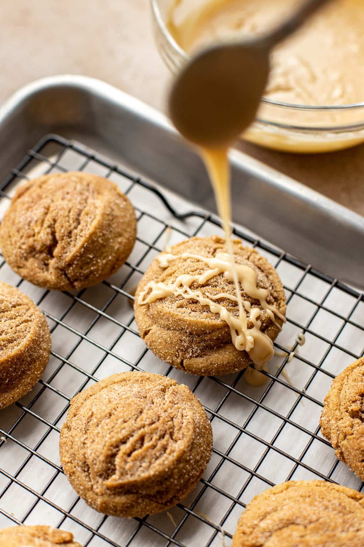 glaze being poured on cookies. 