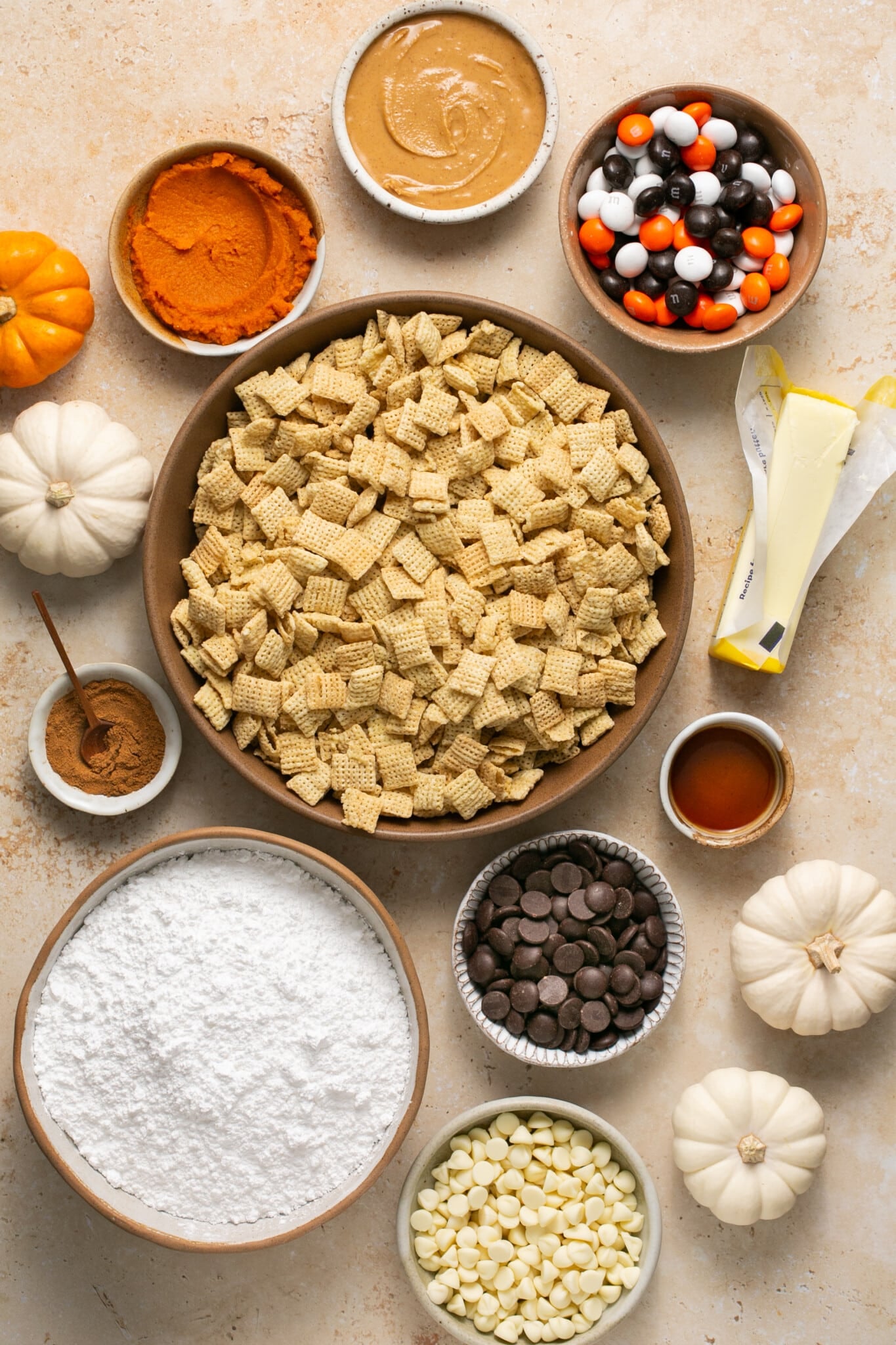 ingredients to make puppy chow in glass bowls. 