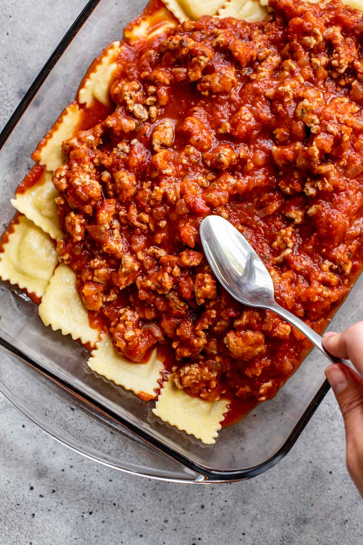 Meat sauce on top of ravioli. 