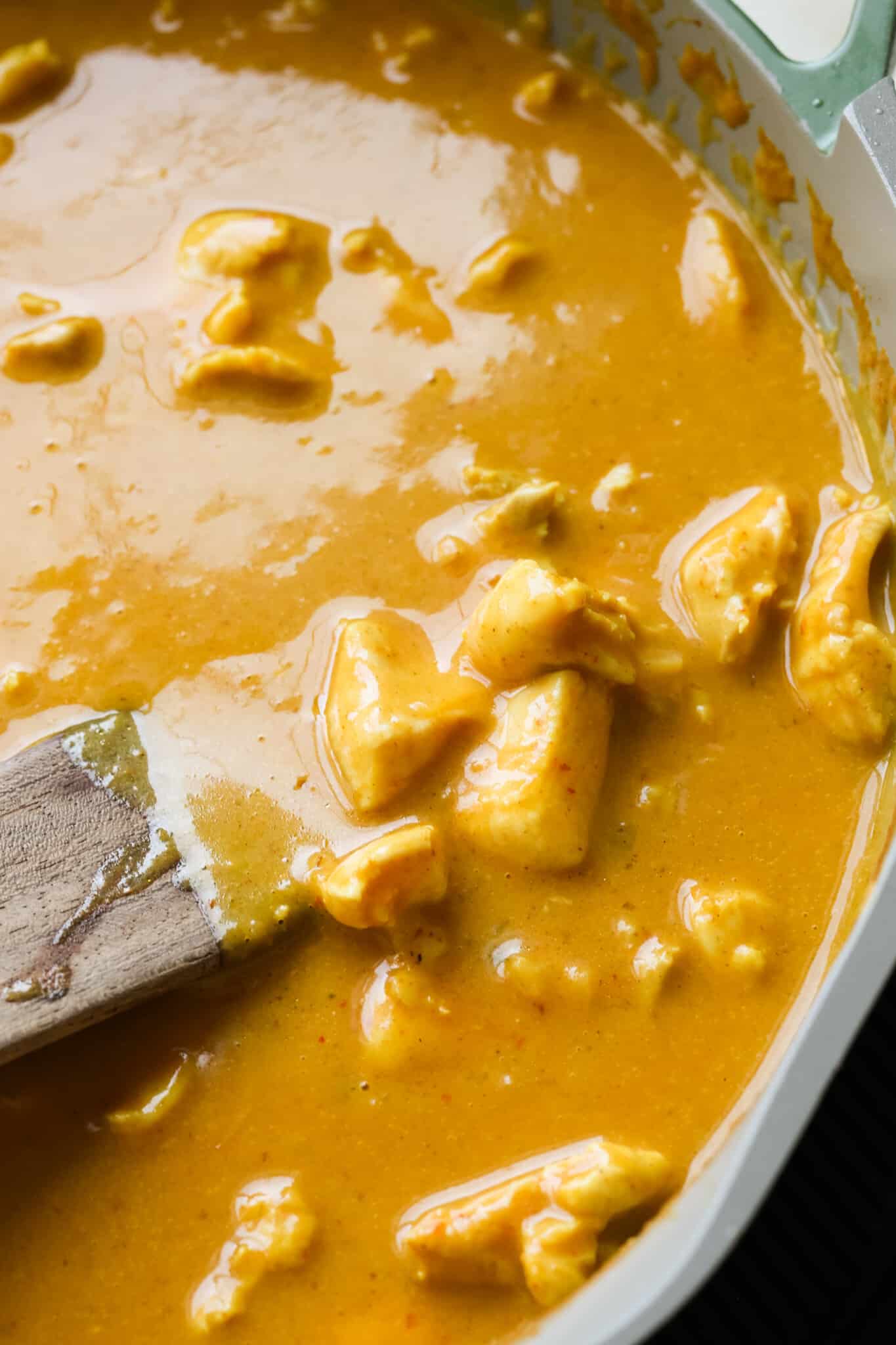 chicken curry in a saute pan. 