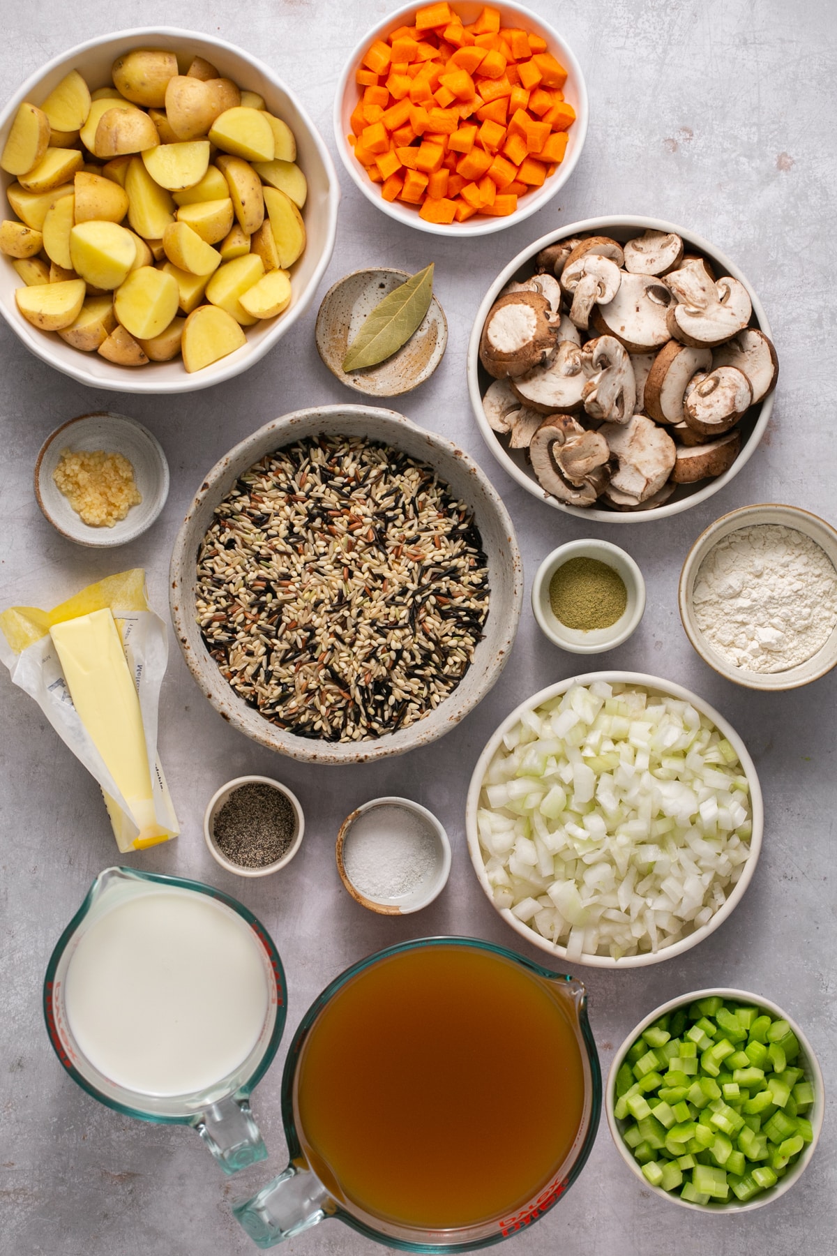 ingredients to make soup in white glass bowls.