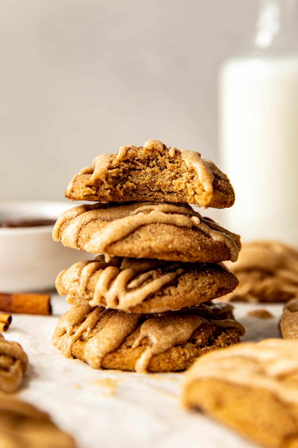 a stack of cookies with a bite taken out of the top cookie. 