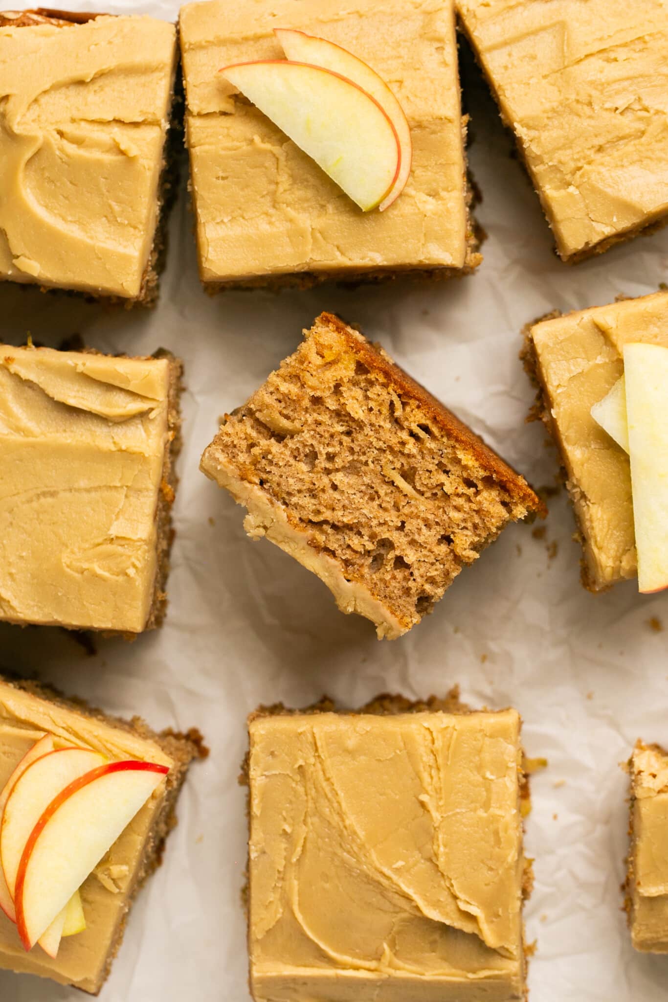 a close up image of an apple cake with a brown sugar icing on top. 