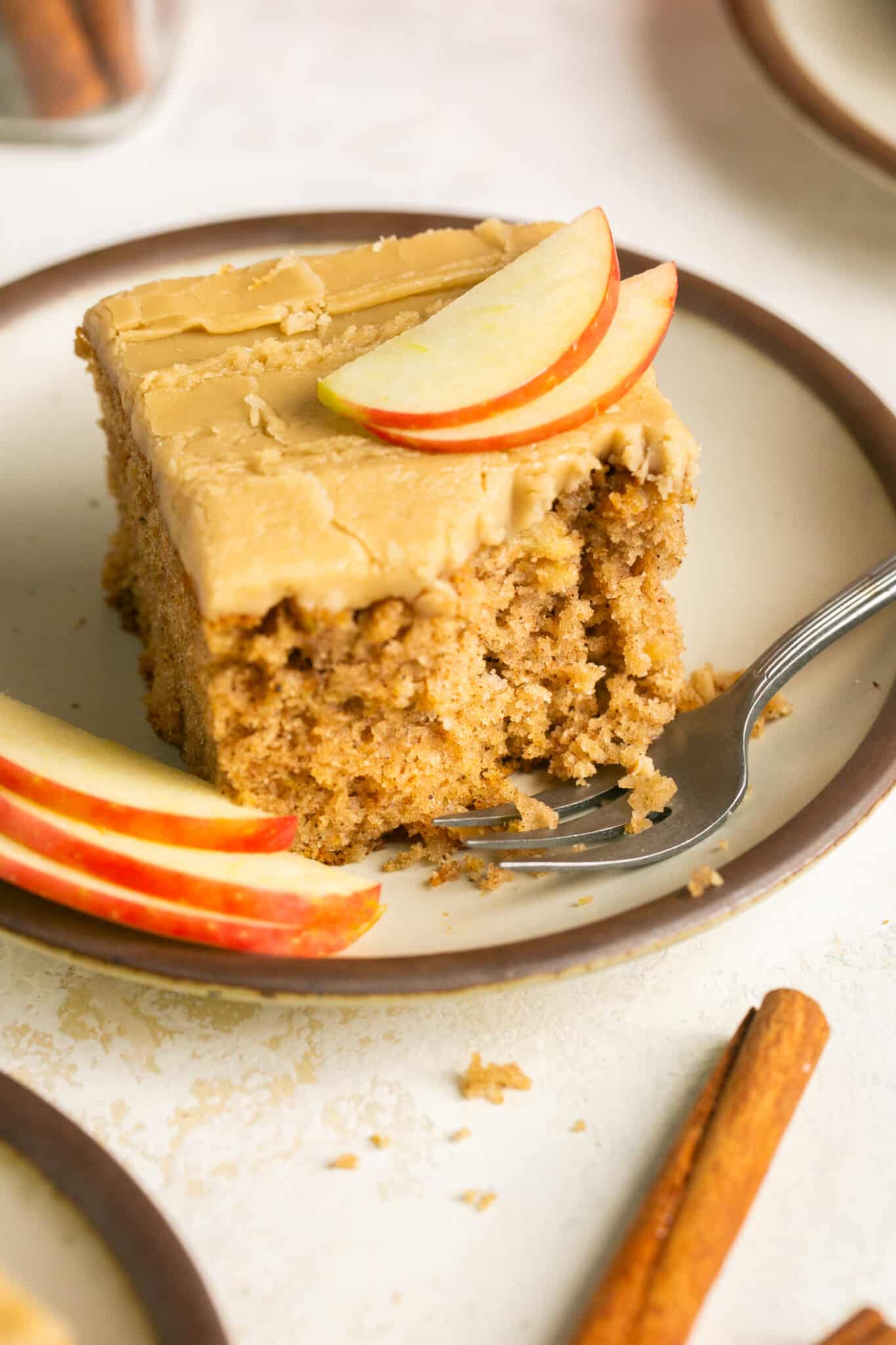 a slice of cake on a plate with a bite taken out of it. 