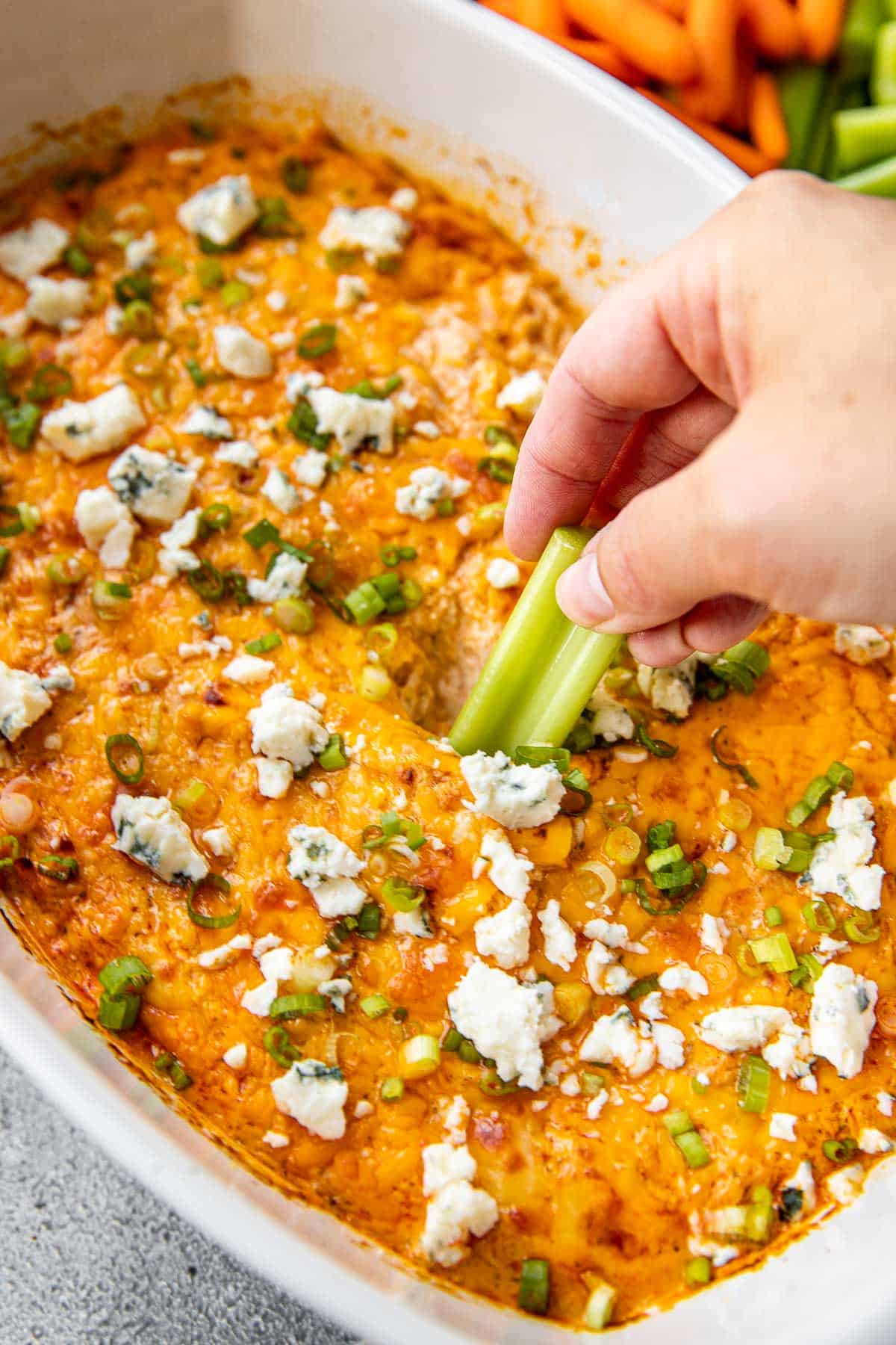 celery scooping into buffalo dip. 