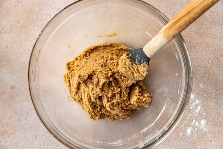 spatula in a clear bowl with cookie dough