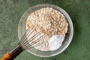 whisk with dry cookie ingredients in a clear bowl