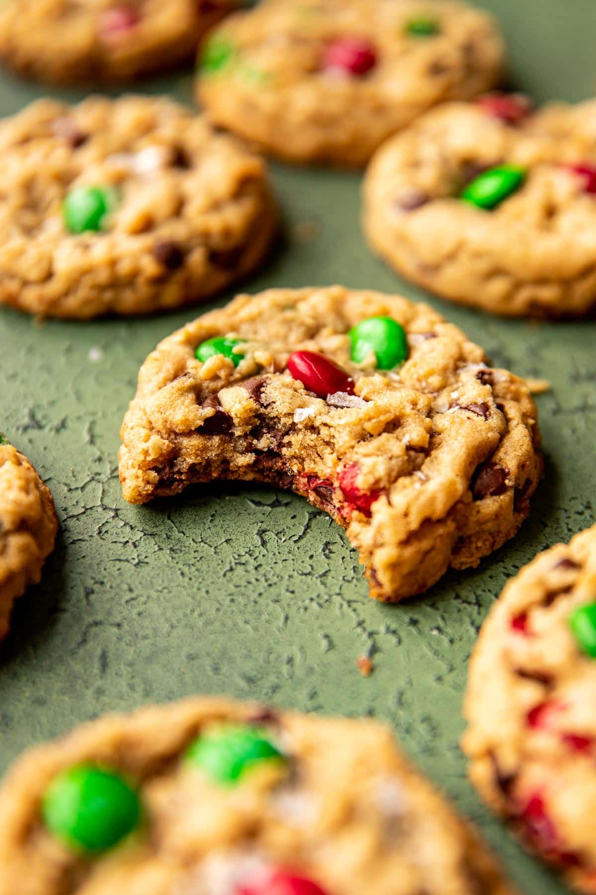 a bite taken out of a cookie made with festive M&Ms. 