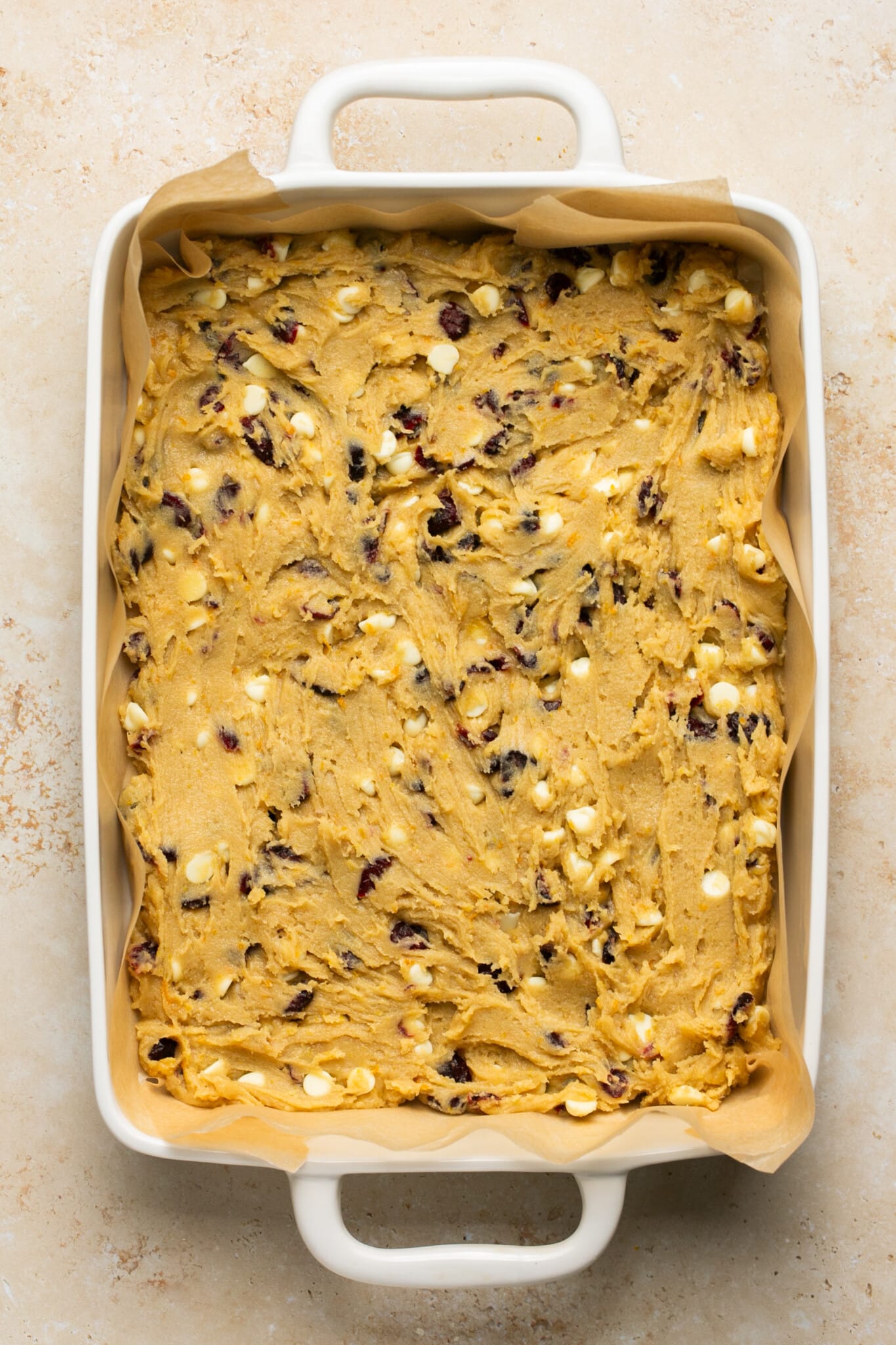 cranberry bliss bar batter spread evenly in a 9x13 white baking dish. 
