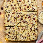 sheet of cranberry bliss bars with triangleur cuts made