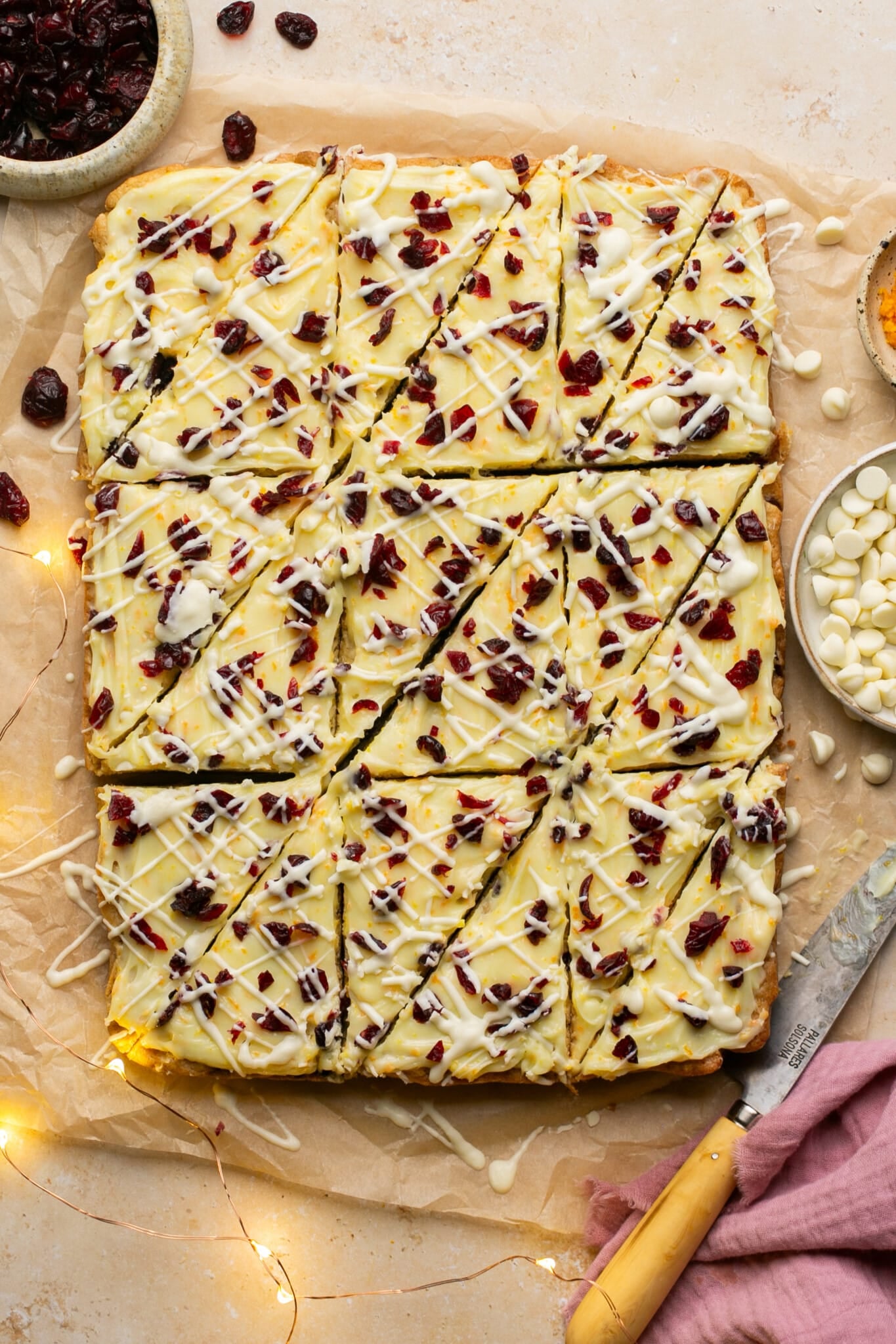 sheet of cranberry bliss bars with triangleur cuts made