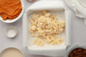 crumbled pie crust prior to pressing into square baking pan