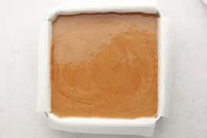 pumpkin pie bars batter uncooked in square baking dish