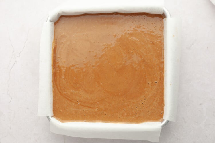 pumpkin pie bars batter uncooked in square baking dish
