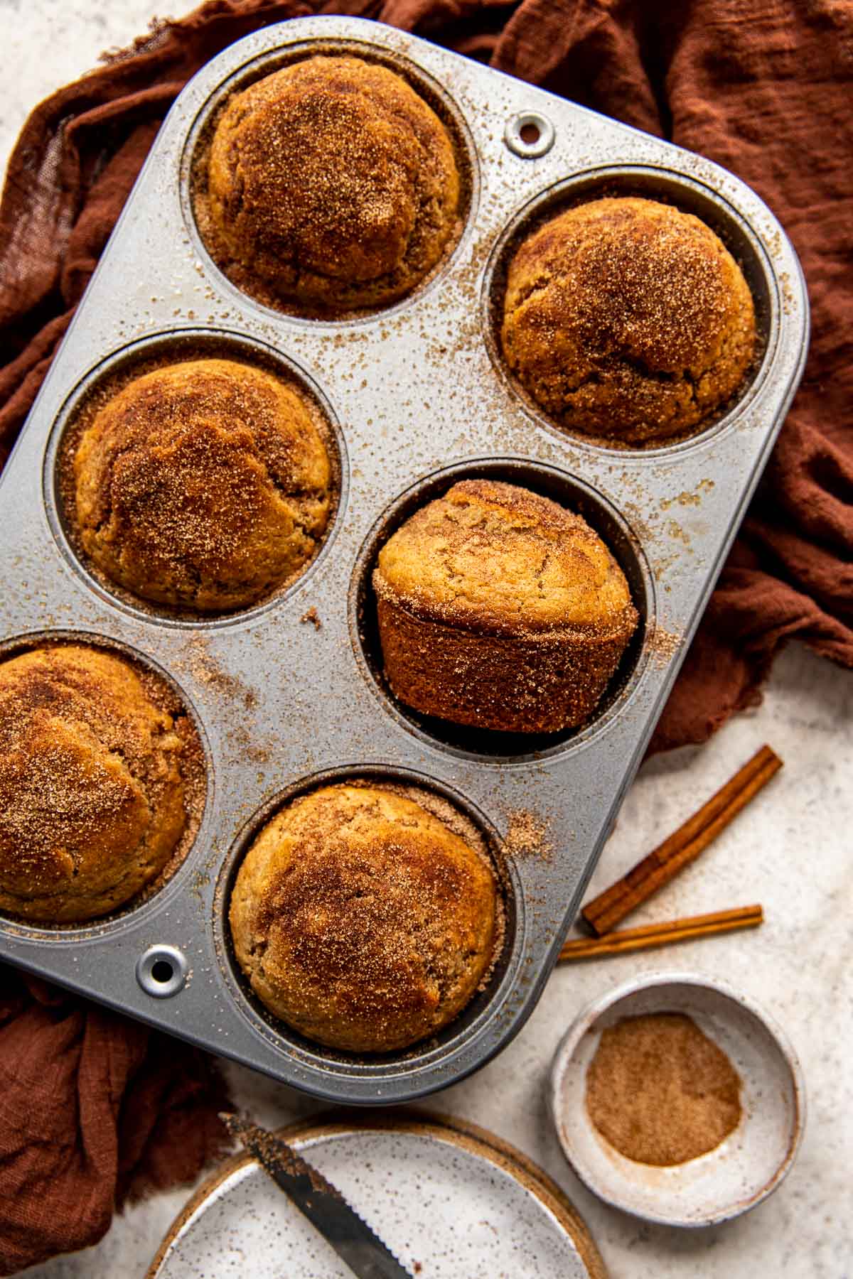 jumbo muffins in a 6 count muffin pan with cinnamon and sugar on top. 