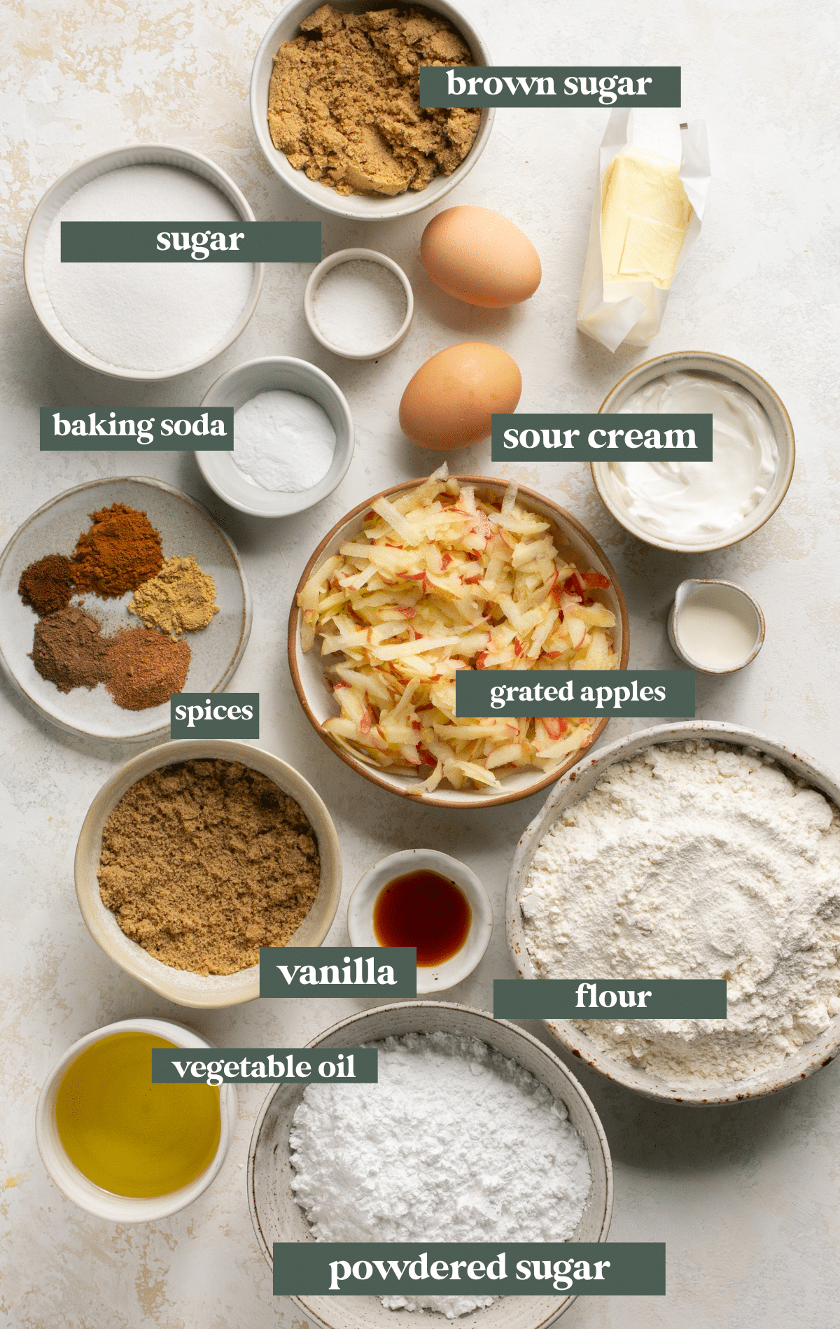ingredients to make an apple cake in glass bowls. 