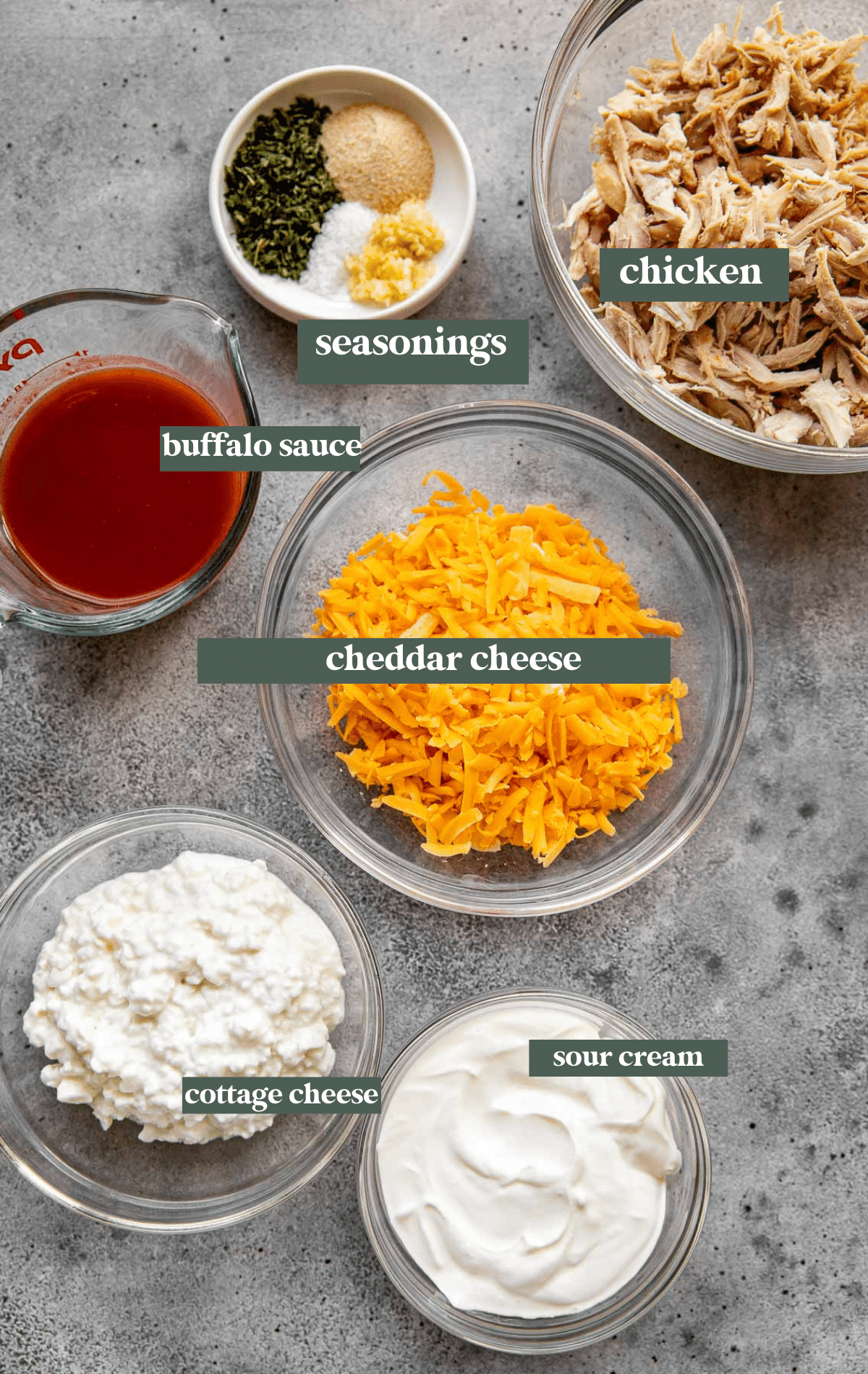 ingredients to make buffalo dip in glass bowls. 