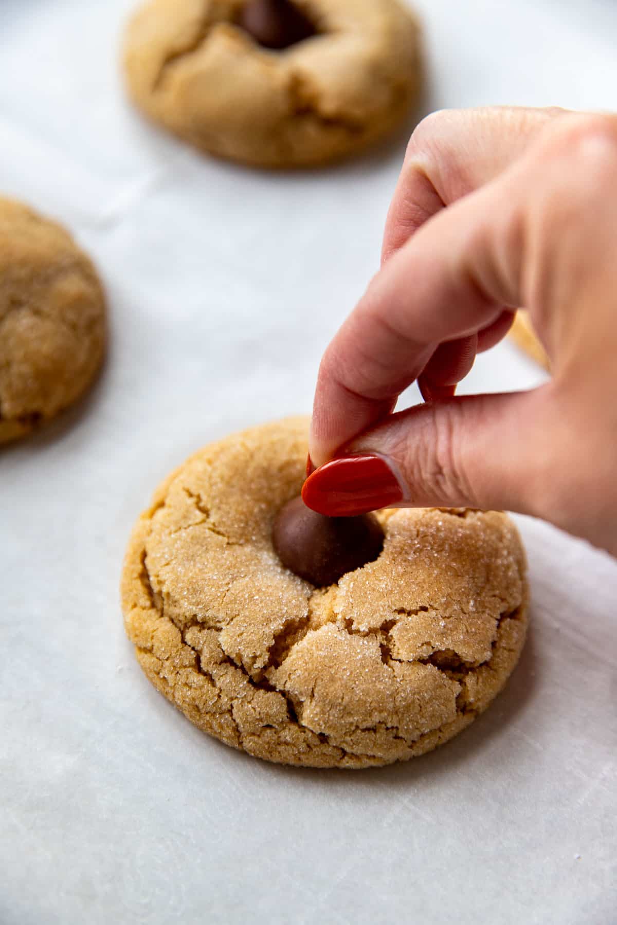 a chocolate kiss pressed on top of a cookie. 