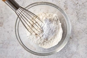 dry ingredients and a whisk in a clear bowl