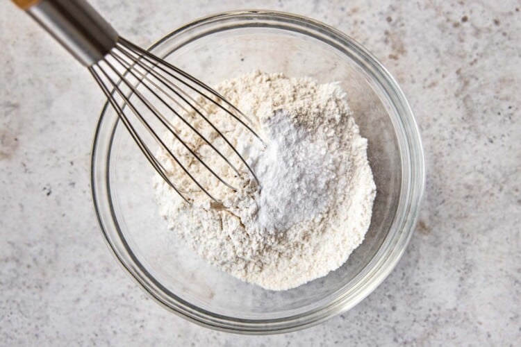 dry ingredients and a whisk in a clear bowl
