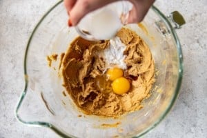 egg and milk being added to fluffernutter cookie ingredients