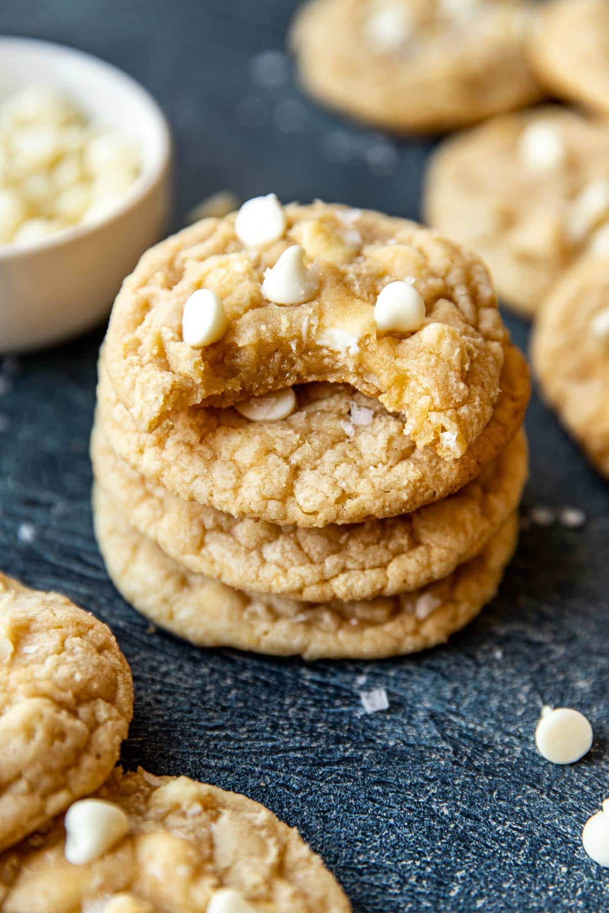a stack of cookie with a bite taken out of the cookie on top. 
