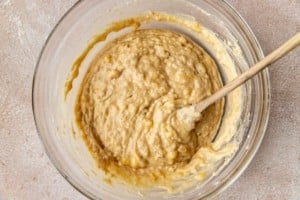 clear bowl with banana bread batter and a spoon