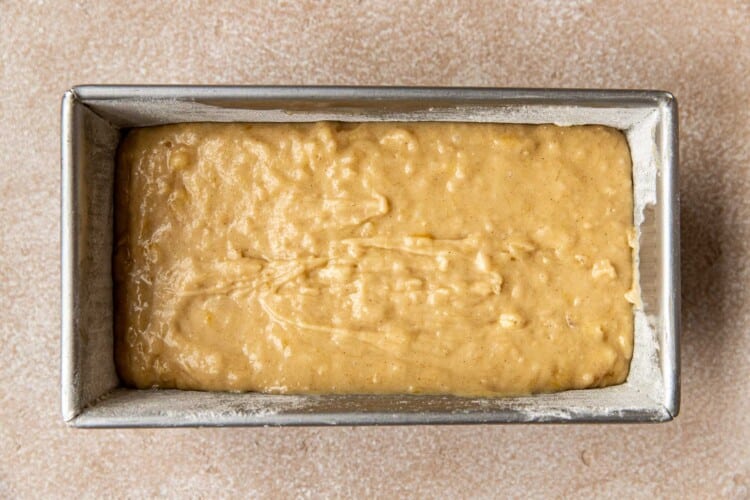 loaf pan with banana bread batter