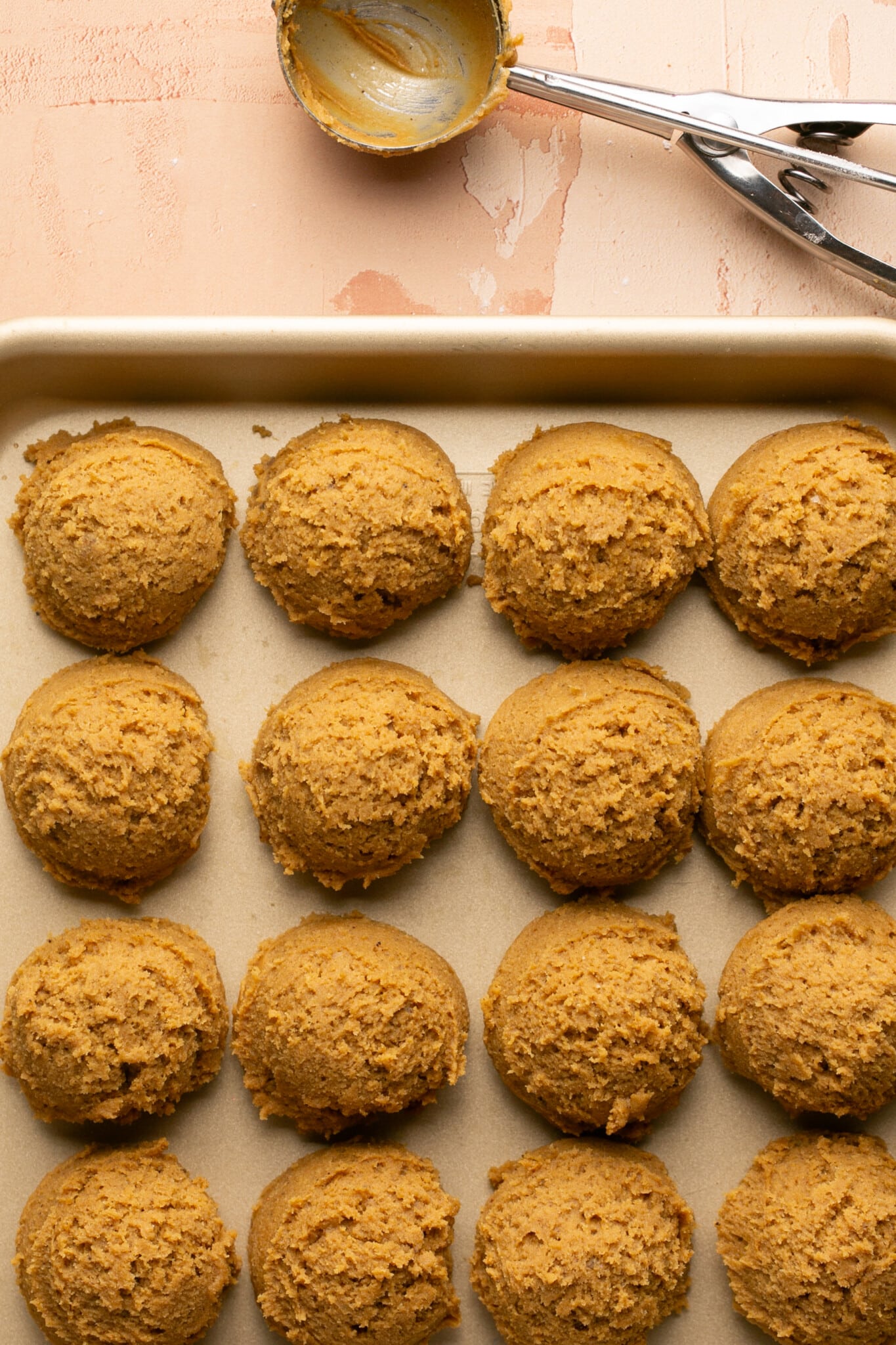 cookie dough scooped onto a baking sheet. 