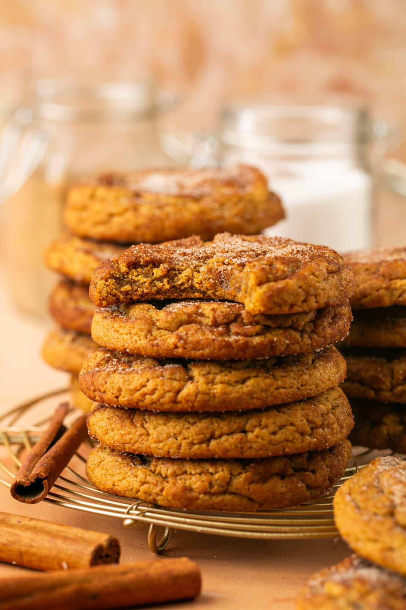 a stack of cookies with a bite taken out of the first cookie on top of the stack. 