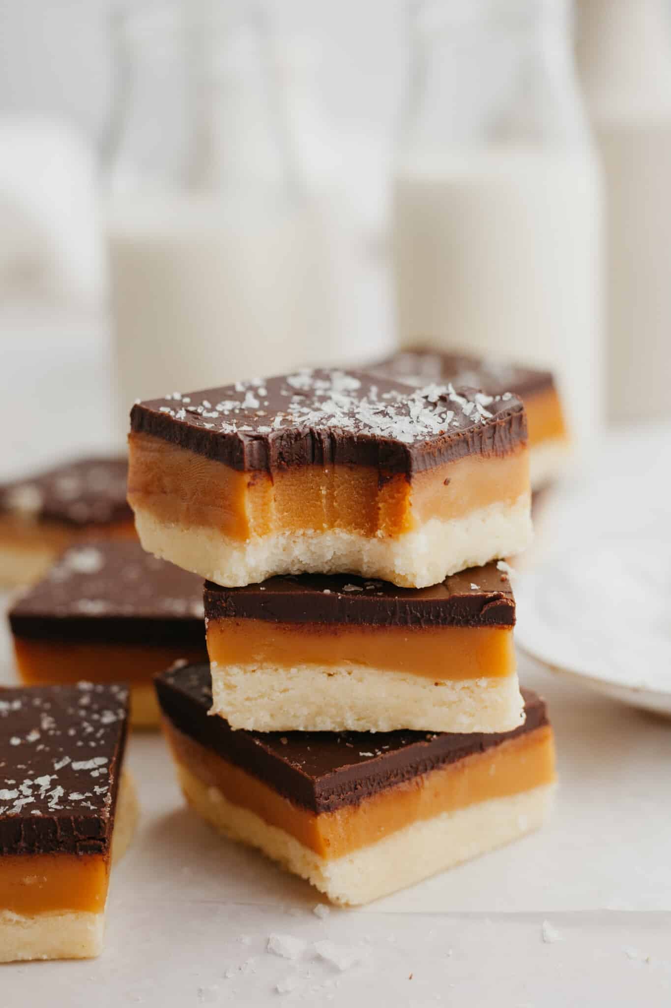 shortbread cookie bars stacked with a bite taken out of the top one
