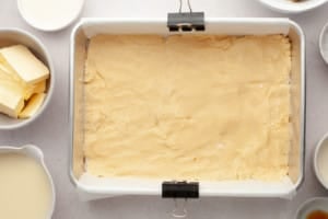baking dish with bottom layer of millionaire bars