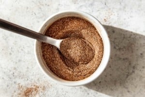cinnamon sugar mix in a white ramekin with a spoon