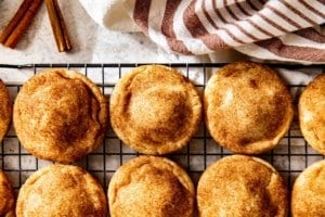 puffy snickerdoodle cookies resting on a cooling rack